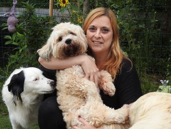 Portrait of smiling mid adult woman with dogs in park