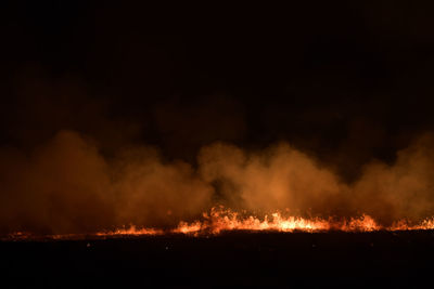 Low angle view of fire against sky at night