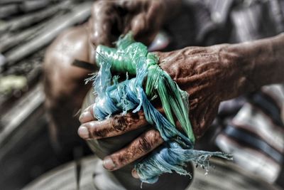 Midsection of man working on pottery wheel