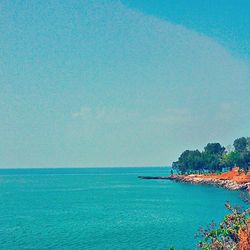 Scenic view of sea against blue sky