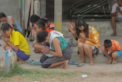 Group of people sitting in city