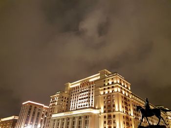 Low angle view of illuminated buildings against sky