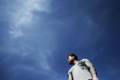 Low angle view of man standing against sky