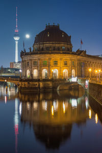 Reflection of illuminated buildings in city at night