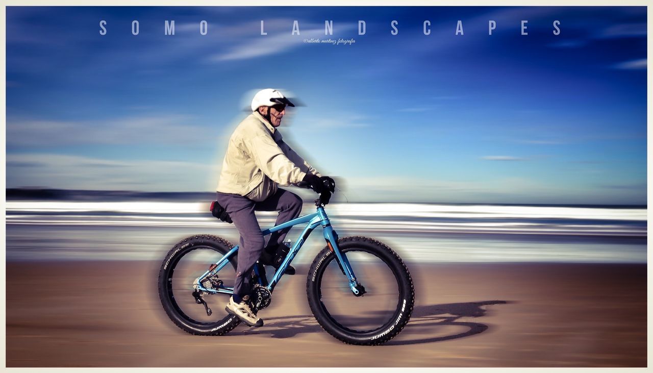 transportation, mode of transport, land vehicle, bicycle, full length, transfer print, side view, casual clothing, road, travel, auto post production filter, on the move, lifestyles, leisure activity, blue, water, sea, young adult, day, outdoors