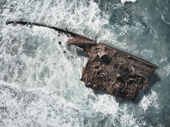 High angle view of waves splashing on sea