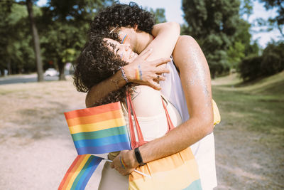 Happy young couple embracing in park