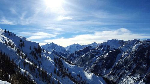 Scenic view of snow covered mountains against sky