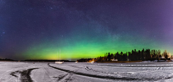 Snow covered landscape against sky at night