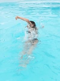 Teenage girl swimming in pool