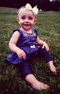 Portrait of a smiling boy sitting on grass