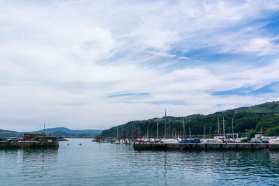 Boats in sea against sky