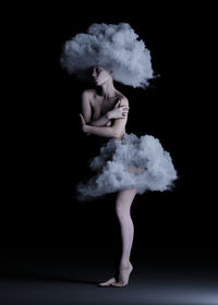 Digital composite image of naked woman with clouds against black background