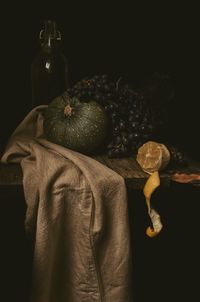 Close-up of fruit on table against black background