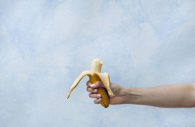Close-up of a hand holding a banana