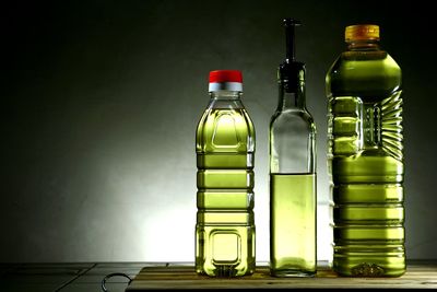 Close-up of oil bottles against black background