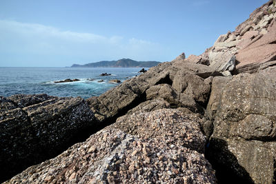 Rocks on beach against sky