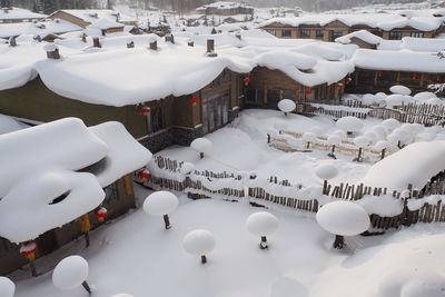 High angle view of snow covered buildings in city