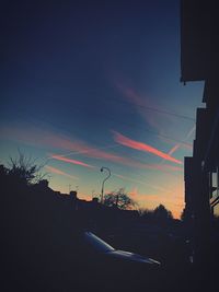 Low angle view of silhouette trees against sky at night