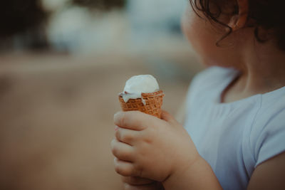 Midsection of child holding ice cream