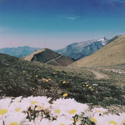 Scenic view of mountains against blue sky