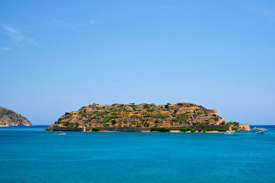 Scenic view of sea against clear blue sky