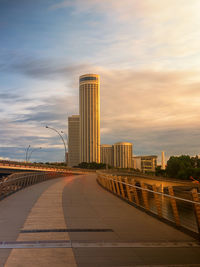 Modern buildings against sky during sunset in city