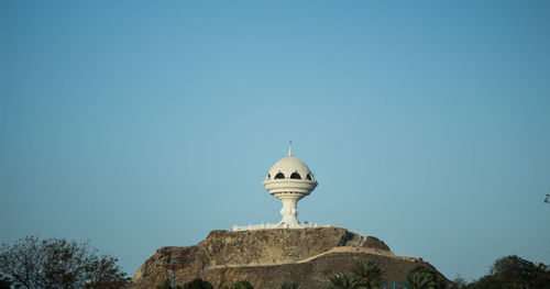 High section of built structure against blue sky