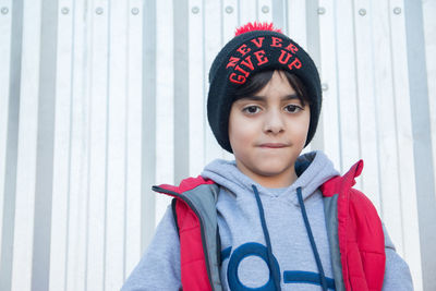 Portrait of boy wearing hat standing in snow