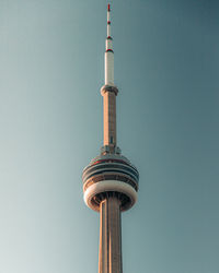 Low angle view of communications tower against blue sky