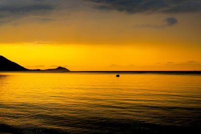 Scenic view of sea against orange sky