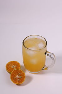 Close-up of orange juice against white background