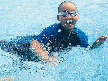 Portrait of man swimming in pool