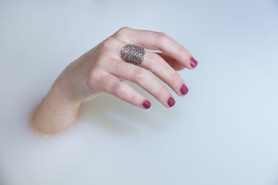 Close-up of woman hand in water