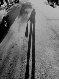 Shadow of people on road