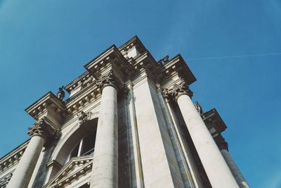Low angle view of historical building against blue sky