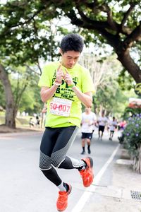 Full length of man running on road during marathon