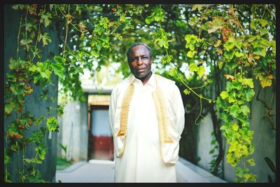 Portrait of senior man in traditional clothing standing outdoors