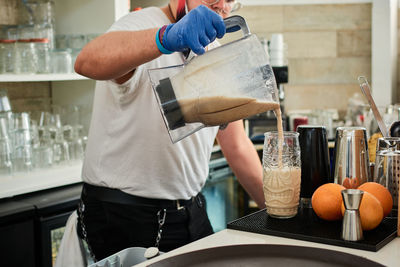 Midsection of man preparing food