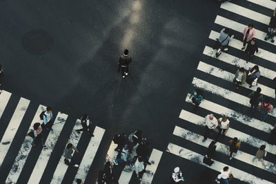 High angle view of people walking on street in city