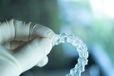 Close-up of person holding plastic braces