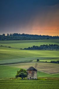 Scenic view of field against sky during sunset