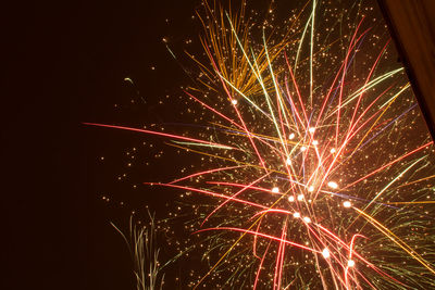 Low angle view of firework display at night