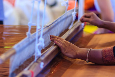 Cropped hands using hand loom