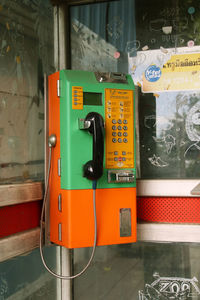 Close-up of telephone booth on wall