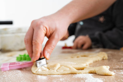 Father feeling playful with his caucasian little daughter, while preparing homemade dough 