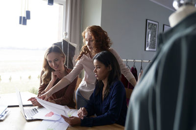 Female colleagues working in workshop