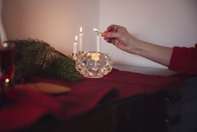 Person lighting christmas candles at home