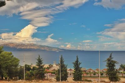 Scenic view of sea and mountains against sky