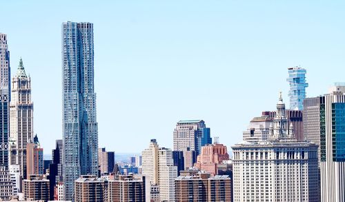 Modern buildings in city against clear sky